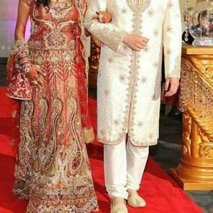 Woman Indian wedding ghaghra and man Sherwani